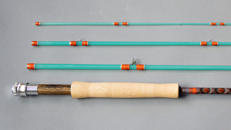 Fly rod in pieces; orange and white guides